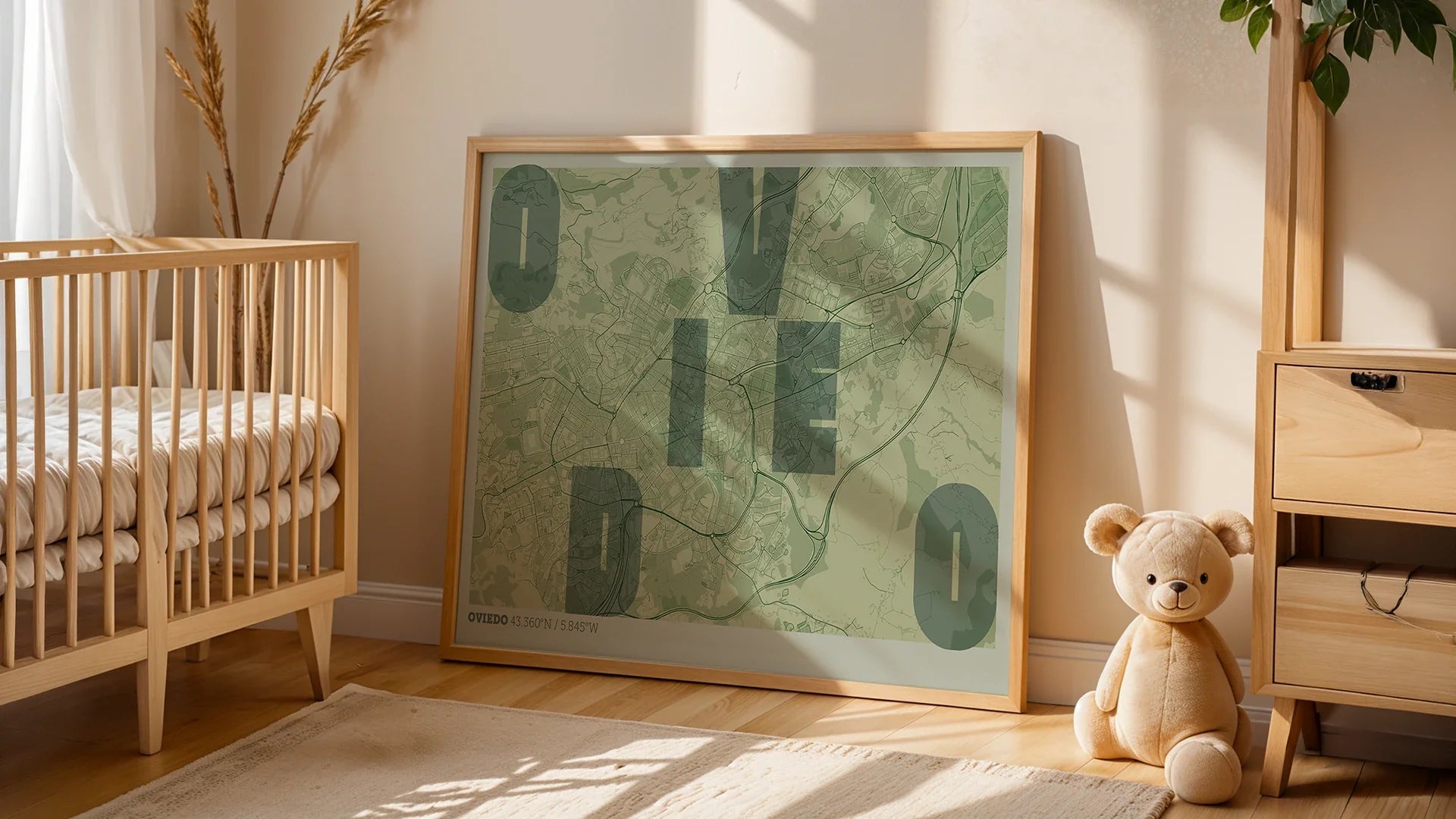 Minimalist Spanish bedroom with a wooden-framed 'OVD' poster (Oviedo's IATA code on a city map) above a low bed. Large windows offer nature views.