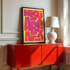 Modern interior design with a Albacete in Inseparable design, featuring the city's abbreviation in expressive typography over a detailed urban map designed in yellow and fuchsia, displayed on a living room wall