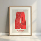 Framed Algeciras in Super Bold design, a typographic poster where the city map is overlaid with extra-thick lettering for a modern, high-impact look designed in red and an off-white background with a white margin border in a warm lit minimalist setting