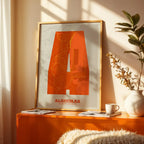 Modern interior design with a Algeciras in Super Bold design, a typographic poster where the city map is overlaid with extra-thick lettering for a modern, high-impact look designed in orange and an off-white background, displayed on a living room wall
