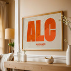 Modern interior design with a Alicante in Super Bold design, a typographic poster where the city map is overlaid with extra-thick lettering for a modern, high-impact look designed in orange and an off-white background, displayed on a living room wall