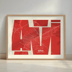 Framed Avila in Inseparable design, featuring the city's abbreviation in expressive typography over a detailed urban map designed in red and an off-white background with a white margin border in a warm lit minimalist setting