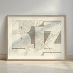 Framed Badajoz in Inseparable design, featuring the city's abbreviation in expressive typography over a detailed urban map designed in light brown and an off-white background with a white margin border in a warm lit minimalist setting