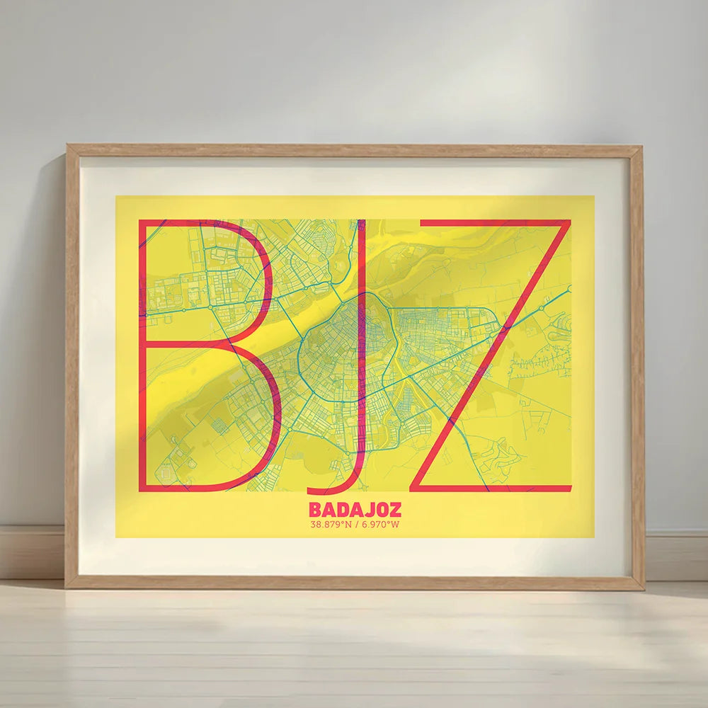 Framed Badajoz in Ultralight design, a minimalist aesthetic combining urban cartography with modern, extra-thin elegant lettering designed in yellow and fuchsia with a white margin border in a warm lit minimalist setting