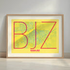Framed Badajoz in Ultralight design, a minimalist aesthetic combining urban cartography with modern, extra-thin elegant lettering designed in yellow and fuchsia with a white margin border in a warm lit minimalist setting