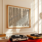 Modern interior design with a Badajoz in Extra Compressed design, where the letters are tightly squeezed to fit the city's map shape designed in light brown and an off-white background, displayed on a living room wall