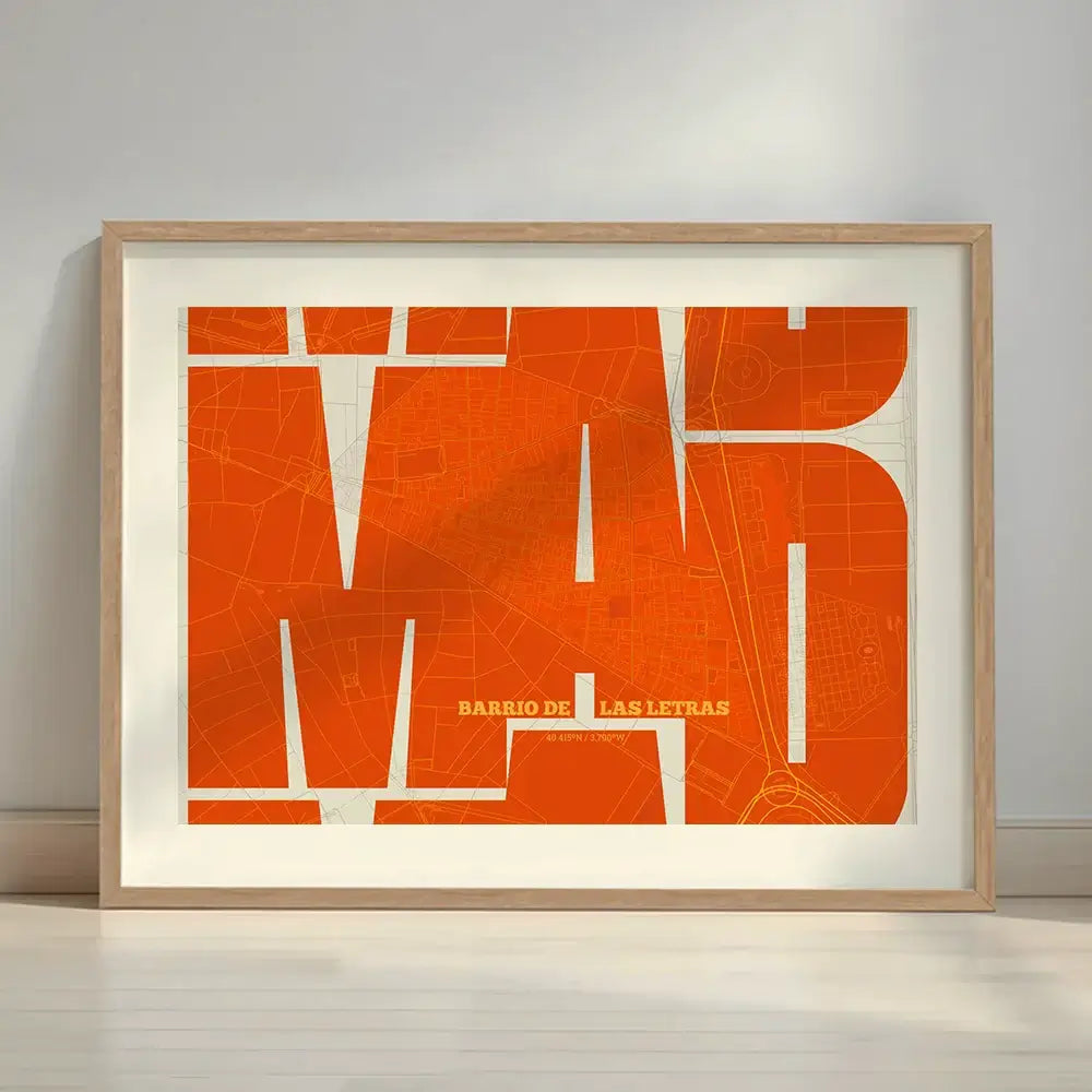 Framed Barrio de Las Letras in Inseparable design, featuring the city's abbreviation in expressive typography over a detailed urban map designed in orange and an off-white background with a white margin border in a warm lit minimalist setting