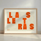 Framed Barrio de Las Letras in Unruled design, where the city name letters appear randomly across different lines for a truly original urban layout designed in orange and an off-white background with a white margin border in a warm lit minimalist setting