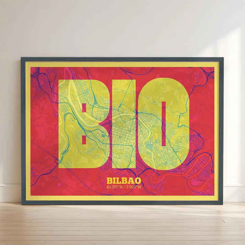 Framed Bilbao in Super Bold design, a typographic poster where the city map is overlaid with extra-thick lettering for a modern, high-impact look designed in yellow and fuchsia with no border edge-to-edge print leaning against a wall