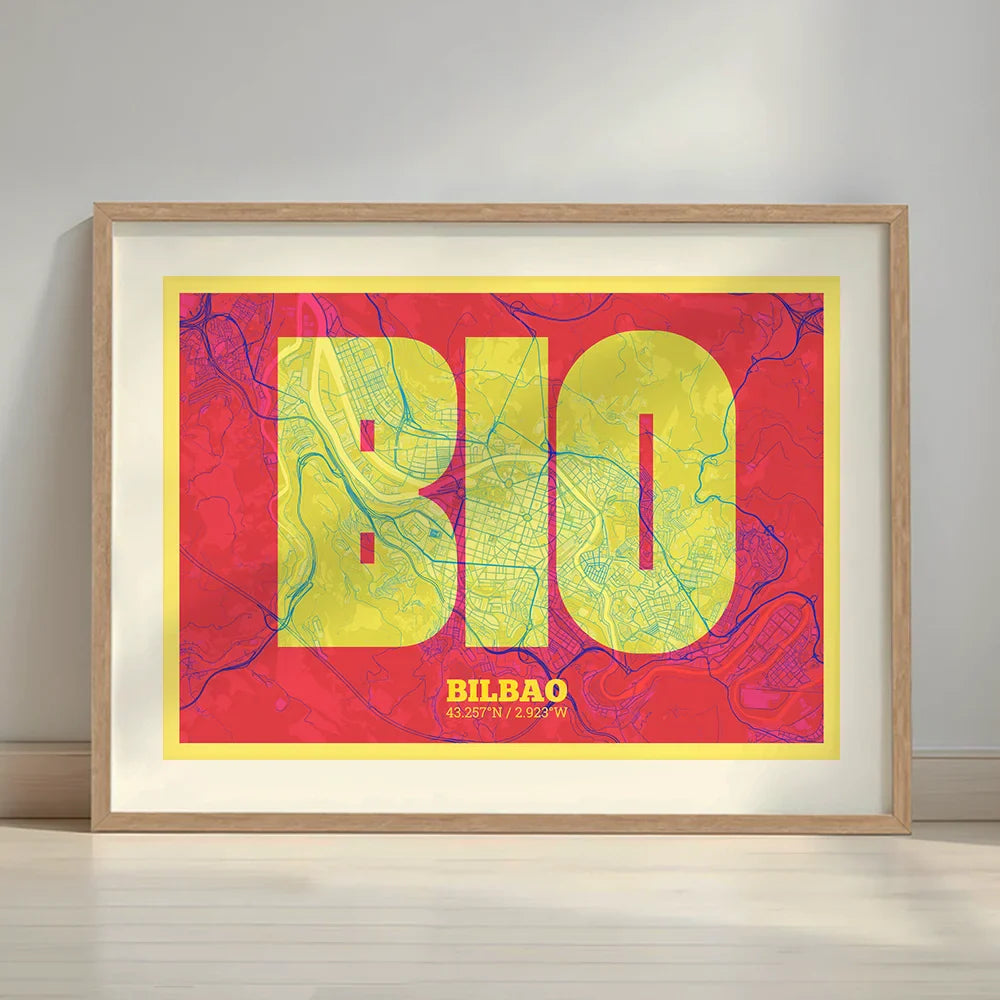 Framed Bilbao in Super Bold design, a typographic poster where the city map is overlaid with extra-thick lettering for a modern, high-impact look designed in yellow and fuchsia with a white margin border in a warm lit minimalist setting