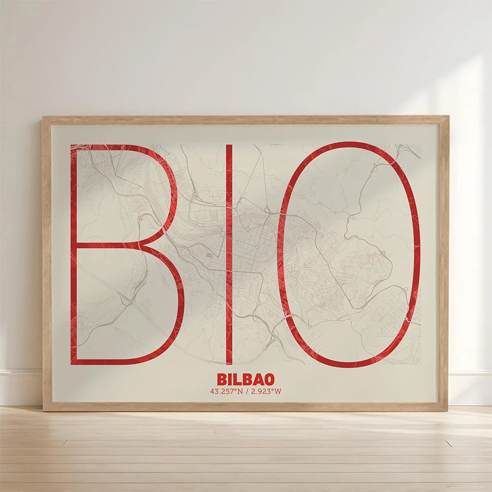 Framed Bilbao in Ultralight design, a minimalist aesthetic combining urban cartography with modern, extra-thin elegant lettering designed in red and an off-white background with no border edge-to-edge print leaning against a wall