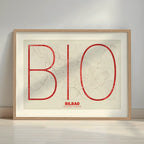 Framed Bilbao in Ultralight design, a minimalist aesthetic combining urban cartography with modern, extra-thin elegant lettering designed in red and an off-white background with a white margin border in a warm lit minimalist setting