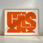 Framed Castellon in Inseparable design, featuring the city's abbreviation in expressive typography over a detailed urban map designed in orange and an off-white background with a white margin border in a warm lit minimalist setting