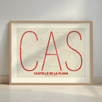 Framed Castellon in Ultralight design, a minimalist aesthetic combining urban cartography with modern, extra-thin elegant lettering designed in red and an off-white background with a white margin border in a warm lit minimalist setting