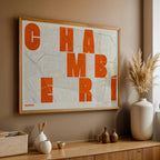 Modern interior design with a Chamberi in Unruled design, where the city name letters appear randomly across different lines for a truly original urban layout designed in orange and an off-white background, displayed on a living room wall