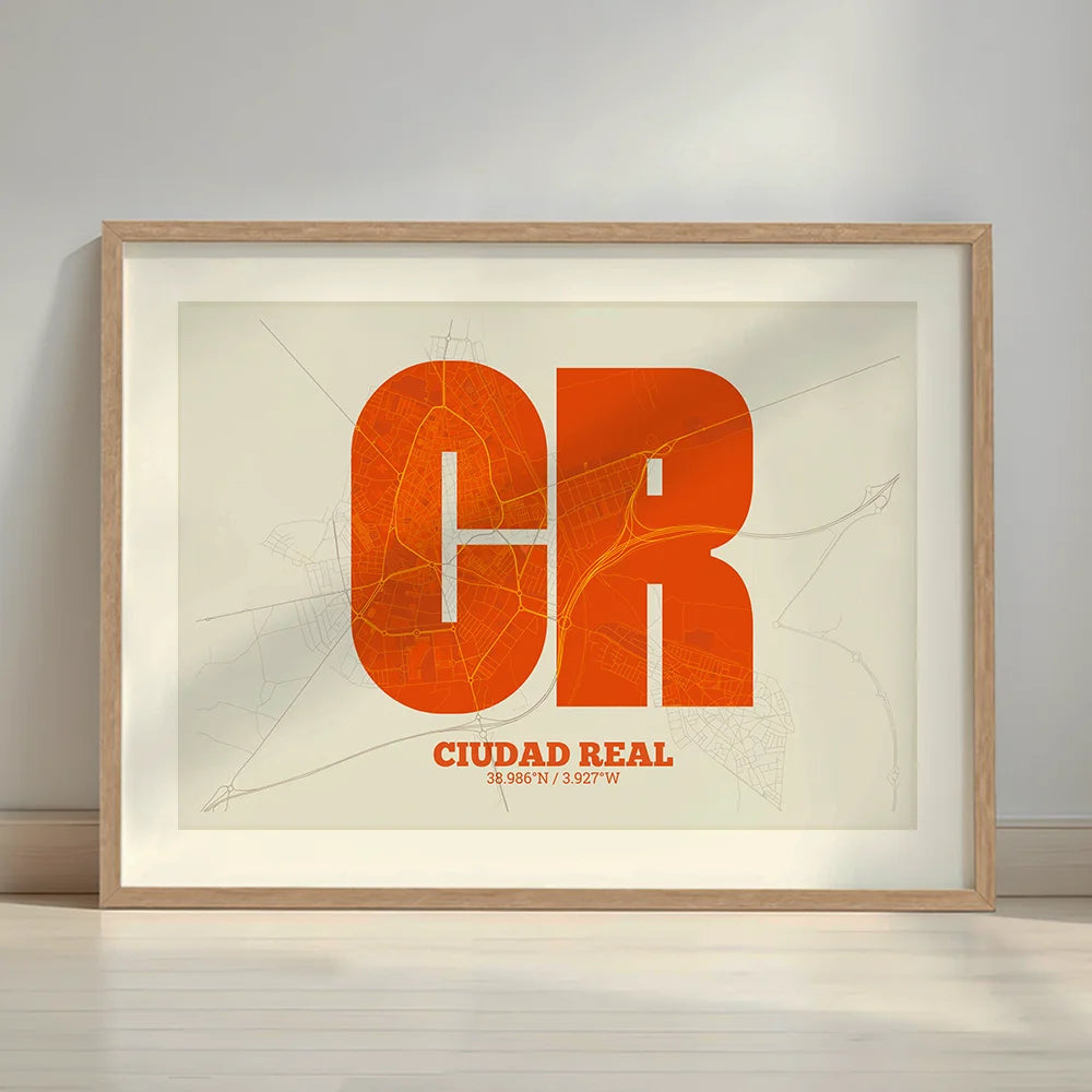 Framed Ciudad Real in Super Bold design, a typographic poster where the city map is overlaid with extra-thick lettering for a modern, high-impact look designed in orange and an off-white background with a white margin border in a warm lit minimalist setting