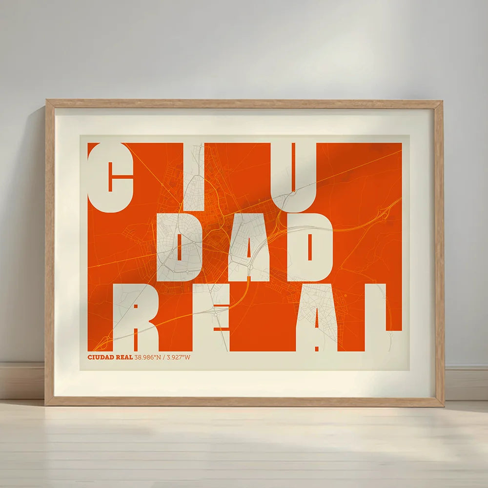 Framed Ciudad Real in Unruled design, where the city name letters appear randomly across different lines for a truly original urban layout designed in orange and an off-white background with a white margin border in a warm lit minimalist setting