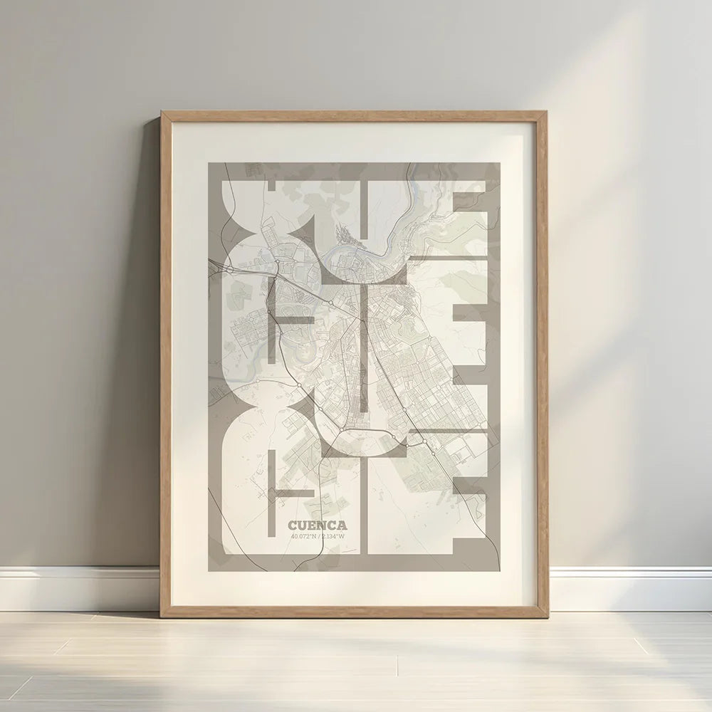 Framed Cuenca in Inseparable design, featuring the city's abbreviation in expressive typography over a detailed urban map designed in light brown and an off-white background with a white margin border in a warm lit minimalist setting
