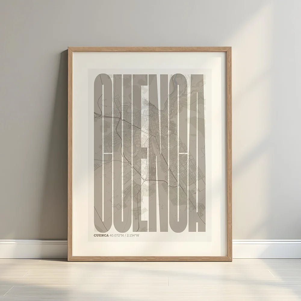 Framed Cuenca in Extra Compressed design, where the letters are tightly squeezed to fit the city's map shape designed in light brown and an off-white background with a white margin border in a warm lit minimalist setting