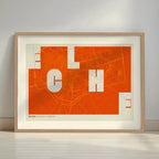 Framed Elche in Unruled design, where the city name letters appear randomly across different lines for a truly original urban layout designed in orange and an off-white background with a white margin border in a warm lit minimalist setting