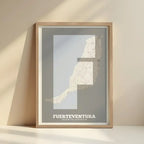 Framed Fuerteventura in Super Bold design, a typographic poster where the city map is overlaid with extra-thick lettering for a modern, high-impact look designed in light brown and an off-white background with no border edge-to-edge print leaning against a wall