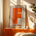 Modern interior design with a Fuerteventura in Super Bold design, a typographic poster where the city map is overlaid with extra-thick lettering for a modern, high-impact look designed in orange and an off-white background, displayed on a living room wall