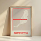 Framed Fuerteventura in Ultralight design, a minimalist aesthetic combining urban cartography with modern, extra-thin elegant lettering designed in red and an off-white background with no border edge-to-edge print leaning against a wall