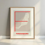 Framed Fuerteventura in Ultralight design, a minimalist aesthetic combining urban cartography with modern, extra-thin elegant lettering designed in red and an off-white background with a white margin border in a warm lit minimalist setting