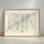 Framed Gijon in Ultralight design, a minimalist aesthetic combining urban cartography with modern, extra-thin elegant lettering designed in light brown and an off-white background with a white margin border in a warm lit minimalist setting