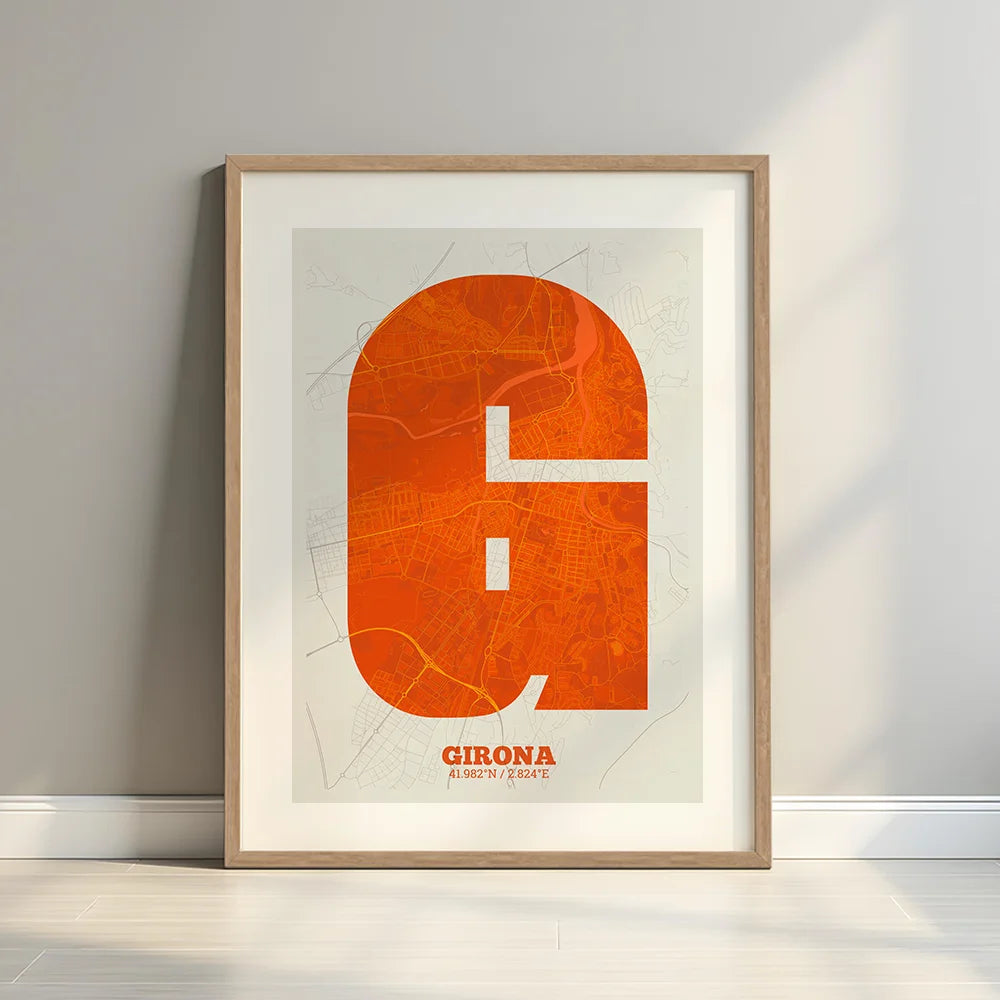 Framed Girona in Super Bold design, a typographic poster where the city map is overlaid with extra-thick lettering for a modern, high-impact look designed in orange and an off-white background with a white margin border in a warm lit minimalist setting