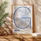 Modern interior design with a Girona in Ultralight design, a minimalist aesthetic combining urban cartography with modern, extra-thin elegant lettering designed in navy blue and white, displayed on a living room wall