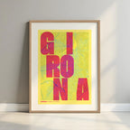 Framed Girona in Unruled design, where the city name letters appear randomly across different lines for a truly original urban layout designed in yellow and fuchsia with a white margin border in a warm lit minimalist setting