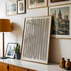 Modern interior design with a Girona in Extra Compressed design, where the letters are tightly squeezed to fit the city's map shape designed in light brown and an off-white background, displayed on a living room wall