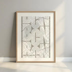 Framed Gracia Quarter in Inseparable design, featuring the city's abbreviation in expressive typography over a detailed urban map designed in light brown and an off-white background with a white margin border in a warm lit minimalist setting