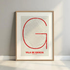 Framed Gracia Quarter in Ultralight design, a minimalist aesthetic combining urban cartography with modern, extra-thin elegant lettering designed in red and an off-white background with a white margin border in a warm lit minimalist setting