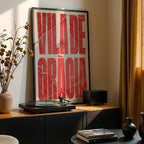 Modern interior design with a Gracia Quarter in Extra Compressed design, where the letters are tightly squeezed to fit the city's map shape designed in red and an off-white background, displayed on a living room wall