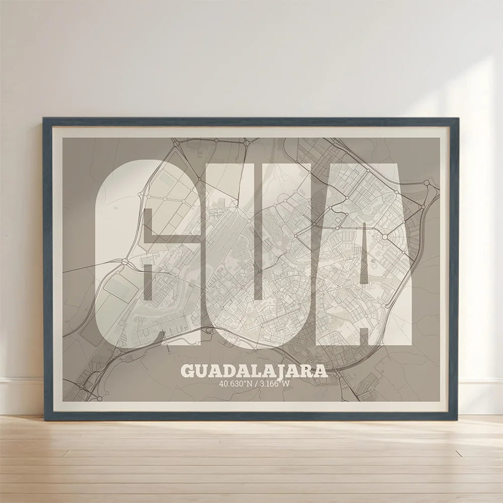 Framed Guadalajara in Super Bold design, a typographic poster where the city map is overlaid with extra-thick lettering for a modern, high-impact look designed in light brown and an off-white background with no border edge-to-edge print leaning against a wall