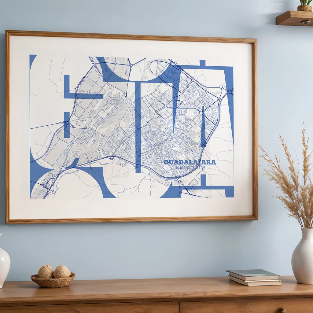 Modern interior design with a Guadalajara in Inseparable design, featuring the city's abbreviation in expressive typography over a detailed urban map designed in navy blue and white, displayed on a living room wall