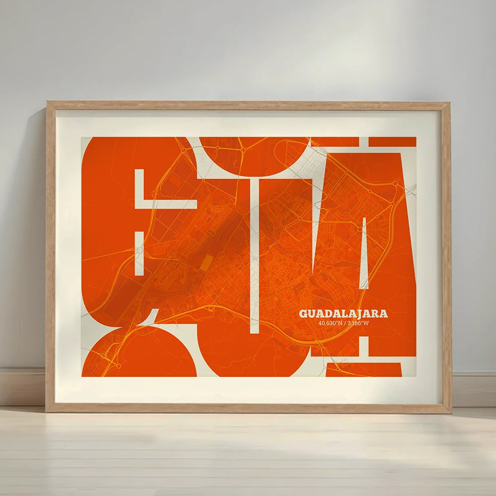 Framed Guadalajara in Inseparable design, featuring the city's abbreviation in expressive typography over a detailed urban map designed in orange and an off-white background with a white margin border in a warm lit minimalist setting