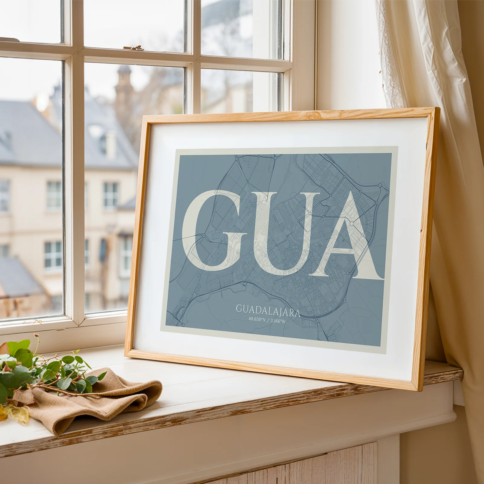 Modern interior design with a Guadalajara in Classic design, inspired by chiseled typography with an elegant font that creates a beautiful visual contrast designed in bluish gray and an off-white background, displayed on a living room wall