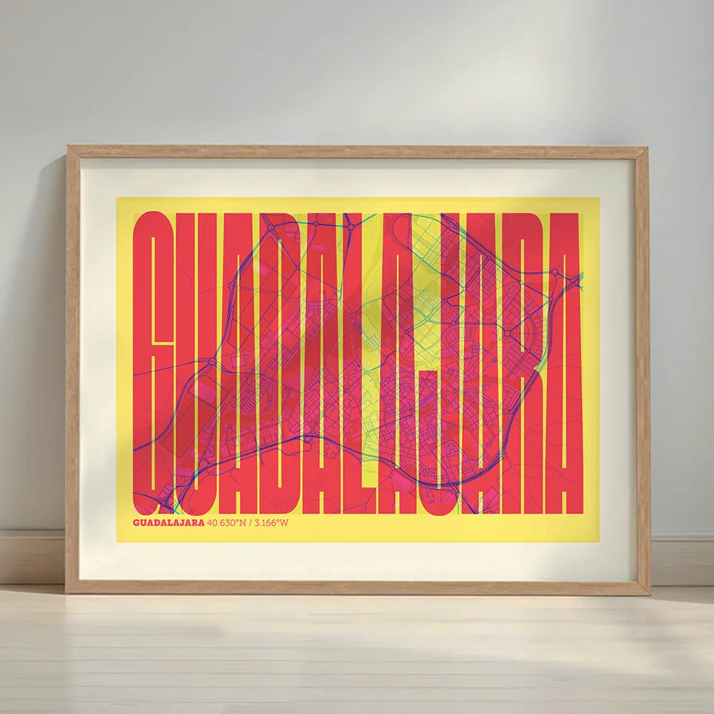Framed Guadalajara in Extra Compressed design, where the letters are tightly squeezed to fit the city's map shape designed in yellow and fuchsia with a white margin border in a warm lit minimalist setting