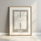 Framed Huesca in Super Bold design, a typographic poster where the city map is overlaid with extra-thick lettering for a modern, high-impact look designed in light brown and an off-white background with a white margin border in a warm lit minimalist setting