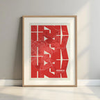 Framed Huesca in Inseparable design, featuring the city's abbreviation in expressive typography over a detailed urban map designed in red and an off-white background with a white margin border in a warm lit minimalist setting