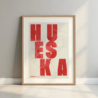 Framed Huesca in Unruled design, where the city name letters appear randomly across different lines for a truly original urban layout designed in red and an off-white background with a white margin border in a warm lit minimalist setting