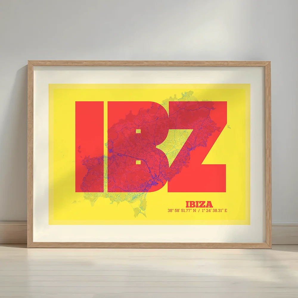 Framed Ibiza in Super Bold design, a typographic poster where the city map is overlaid with extra-thick lettering for a modern, high-impact look designed in yellow and fuchsia with a white margin border in a warm lit minimalist setting