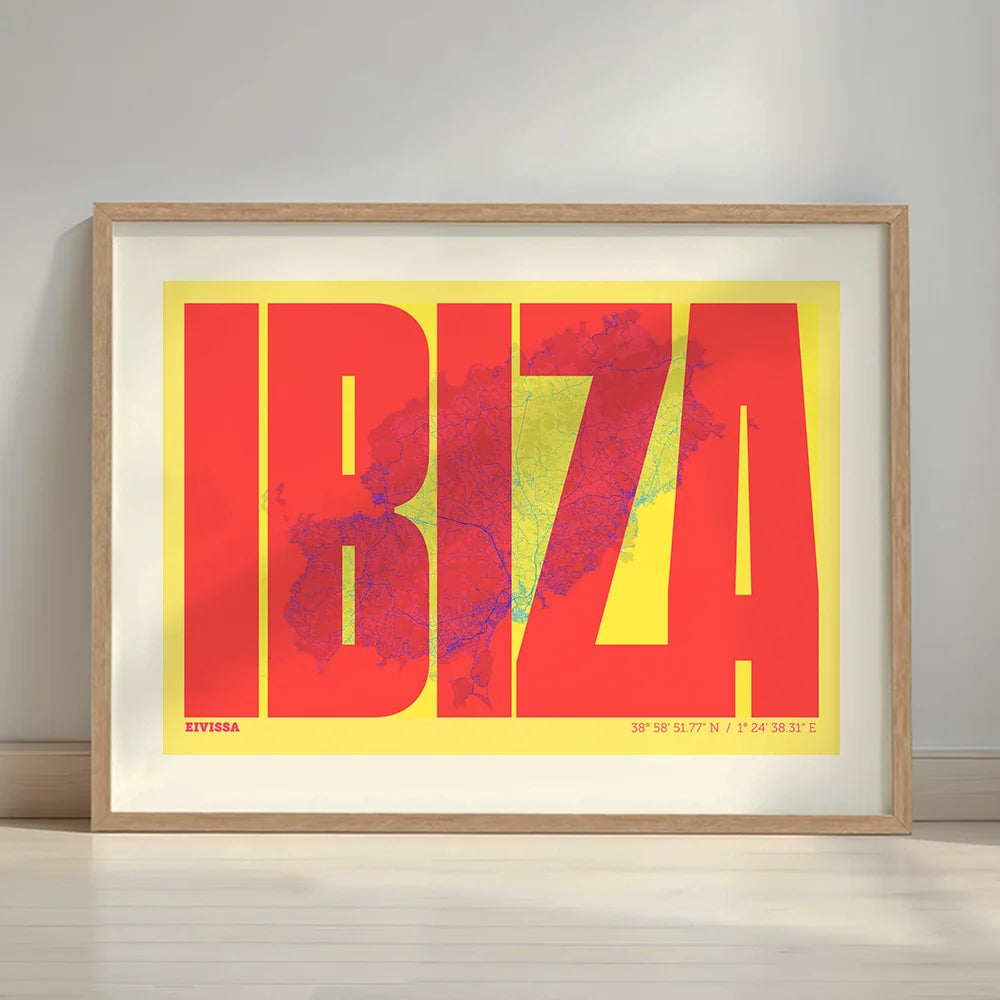 Framed Ibiza in Extra Compressed design, where the letters are tightly squeezed to fit the city's map shape designed in yellow and fuchsia with a white margin border in a warm lit minimalist setting