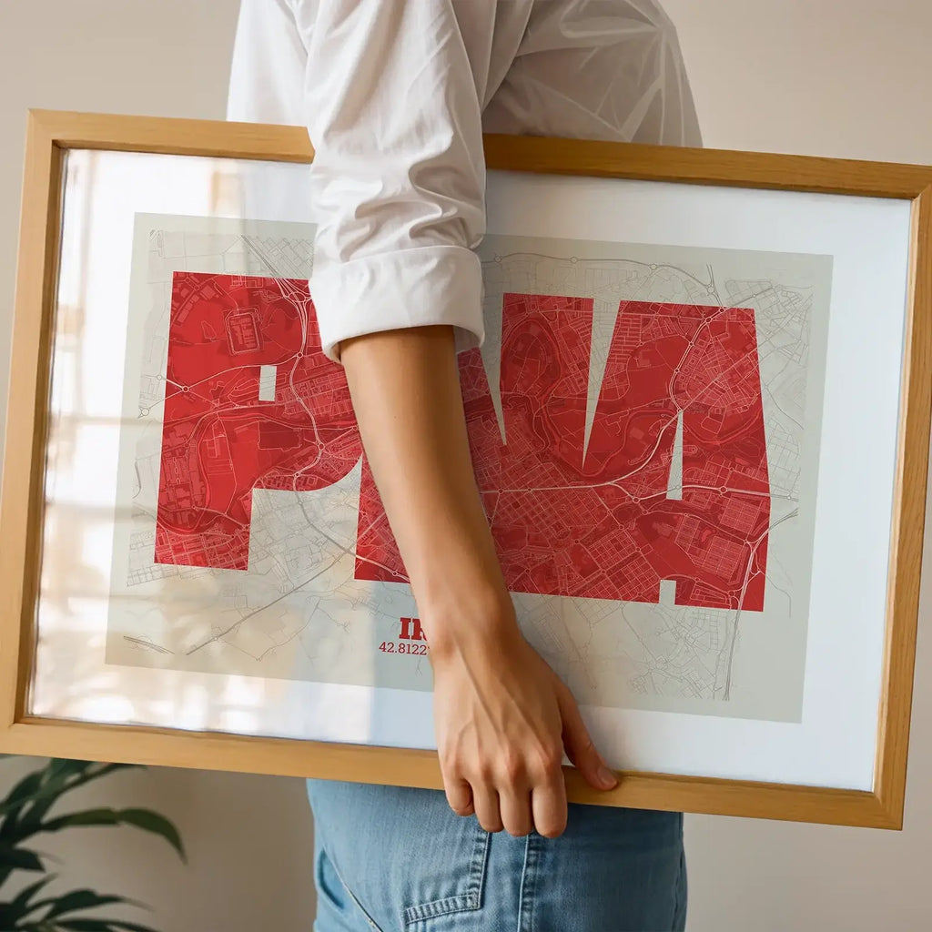 Modern interior design with a Iruña in Super Bold design, a typographic poster where the city map is overlaid with extra-thick lettering for a modern, high-impact look designed in red and an off-white background, displayed on a living room wall