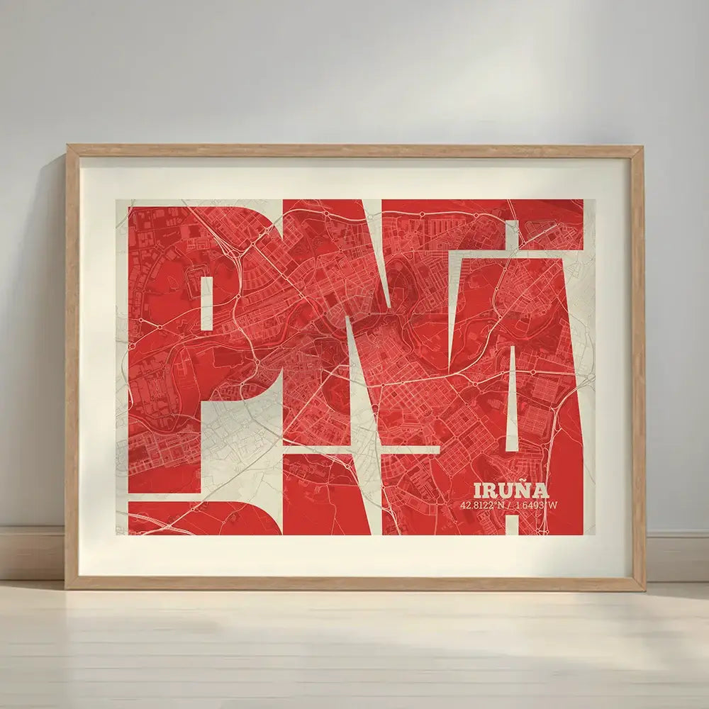 Framed Iruña in Inseparable design, featuring the city's abbreviation in expressive typography over a detailed urban map designed in red and an off-white background with a white margin border in a warm lit minimalist setting