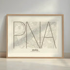 Framed Iruña in Ultralight design, a minimalist aesthetic combining urban cartography with modern, extra-thin elegant lettering designed in light brown and an off-white background with a white margin border in a warm lit minimalist setting