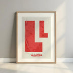 Framed La Latina, Madrid, in Super Bold design, a typographic poster where the city map is overlaid with extra-thick lettering for a modern, high-impact look designed in red and an off-white background with a white margin border in a warm lit minimalist setting